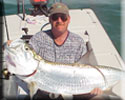 Angler holds up a nice tarpon caught while fishing in the Florida Keys
