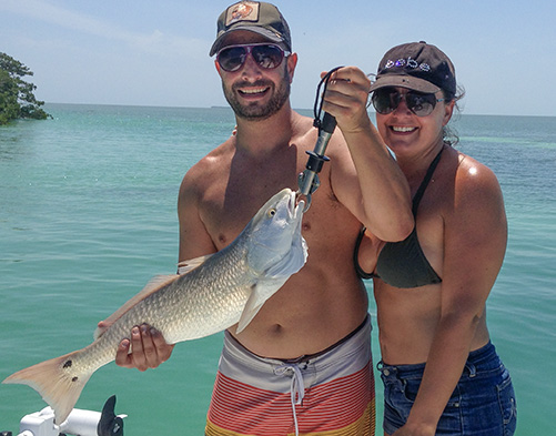 Islamorada backcountry Fishing red fish with a couple